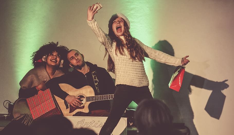 Three people playing music and enjoying it