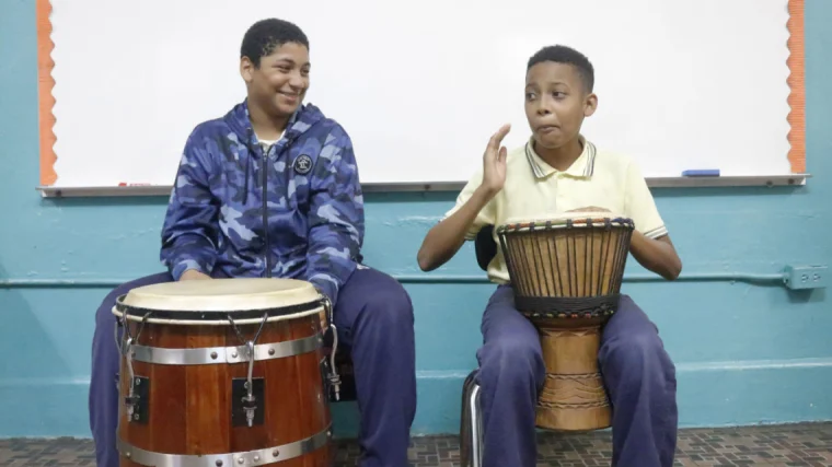 Two children from Puerto Rico playing percussion