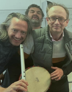 Three members of New Note, one with a large whistle and another with a drum